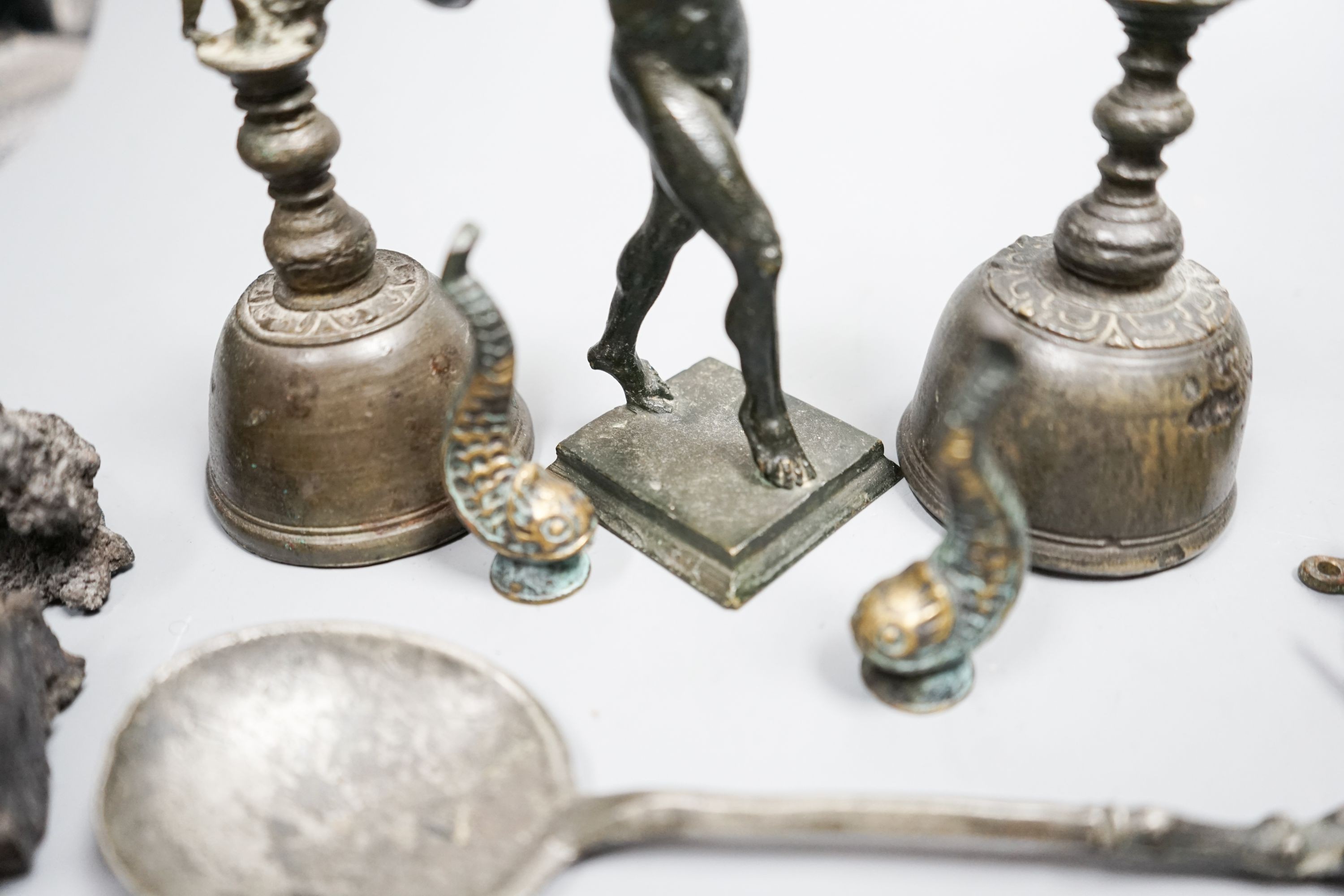 A small quantity of decorative metalware, including two bronze table bells, a bronze faun, 17cm, pewter spoons, etc.